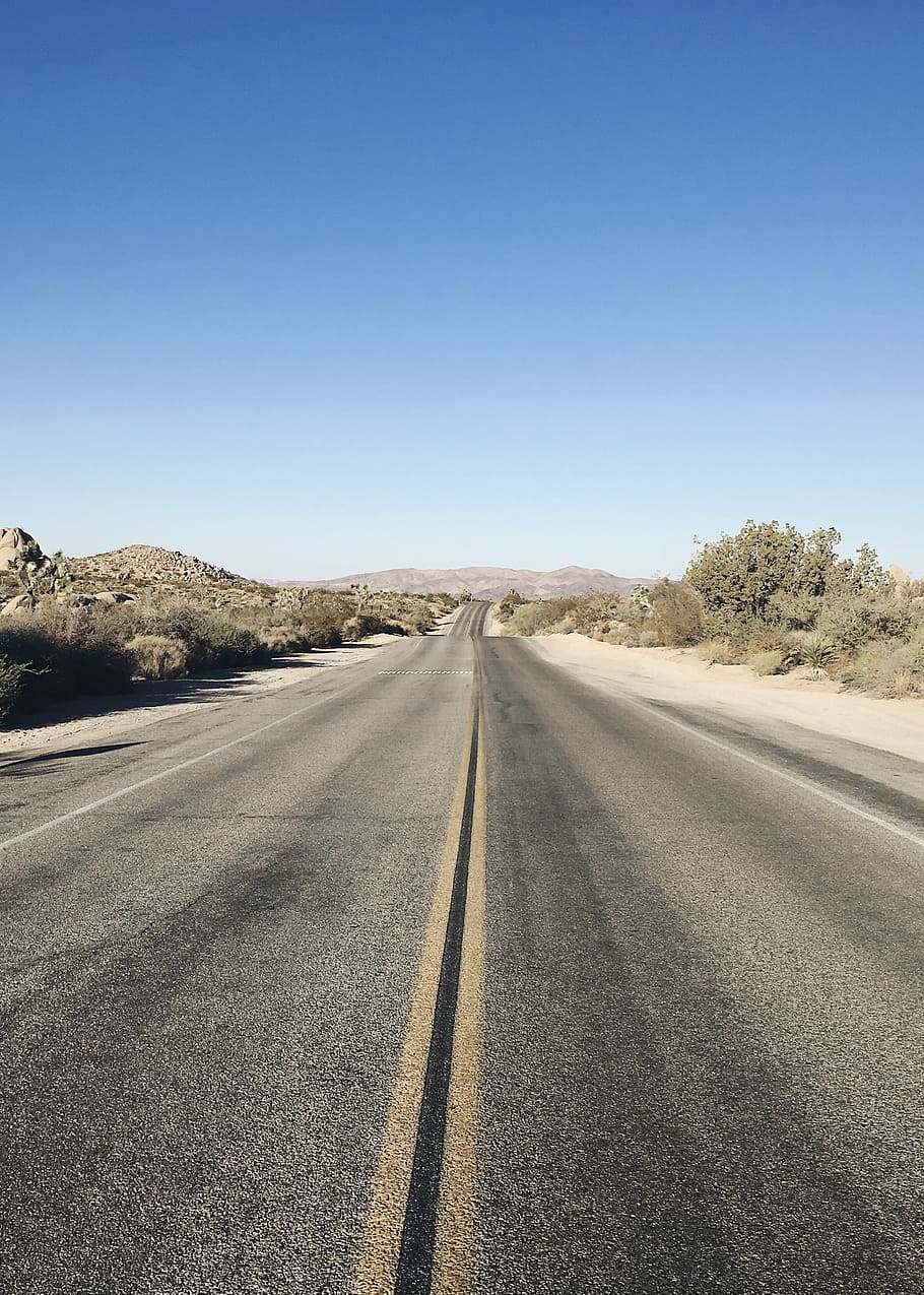 gray asphalt road pathway during daytime, gray asphalted road on desert with no cars on it under blue sky HD wallpaper