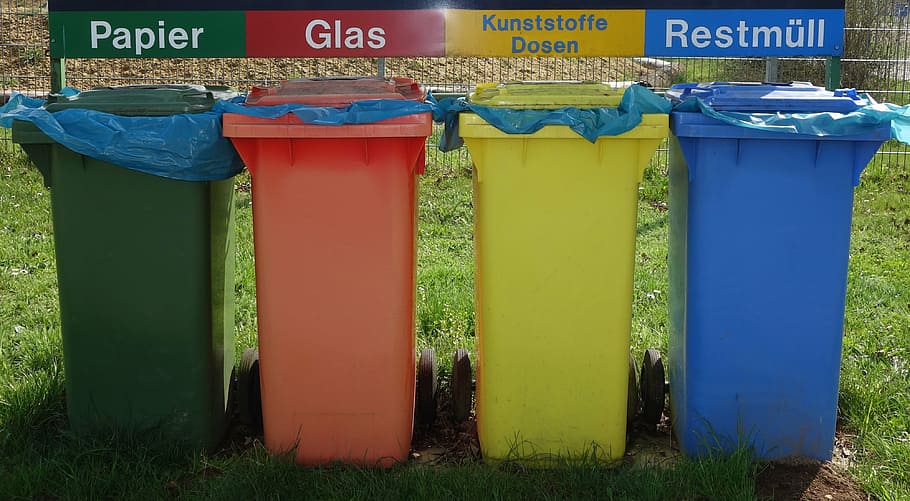 four assorted-color plastic organized garbage bins, waste separation