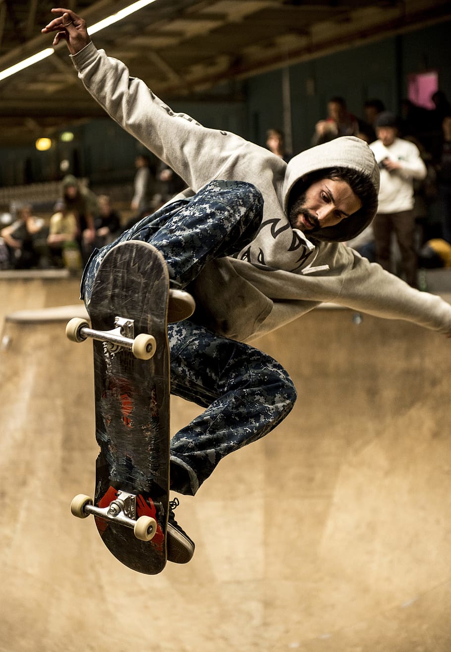 man riding skateboard and doing ollie trick, man in gray hoodie riding skateboard, HD wallpaper