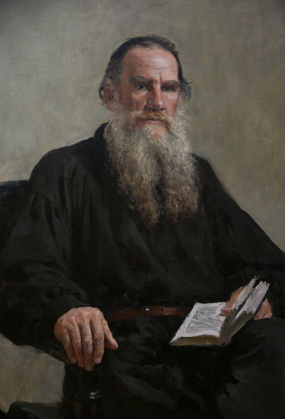 man holding book painting, moscow, tolstoy, writer, table, only men