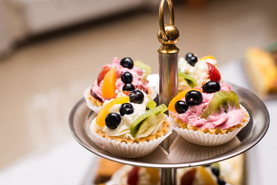 four tarts with fruit toppings placed on round gray cupcake stand selective focus photo, HD wallpaper