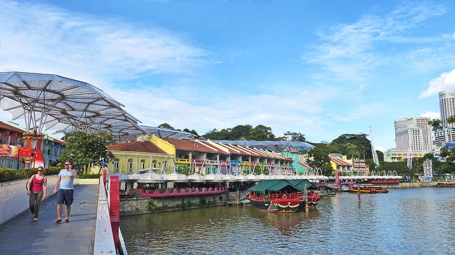 two persons walking near body of water during daytime, Clarke Quay