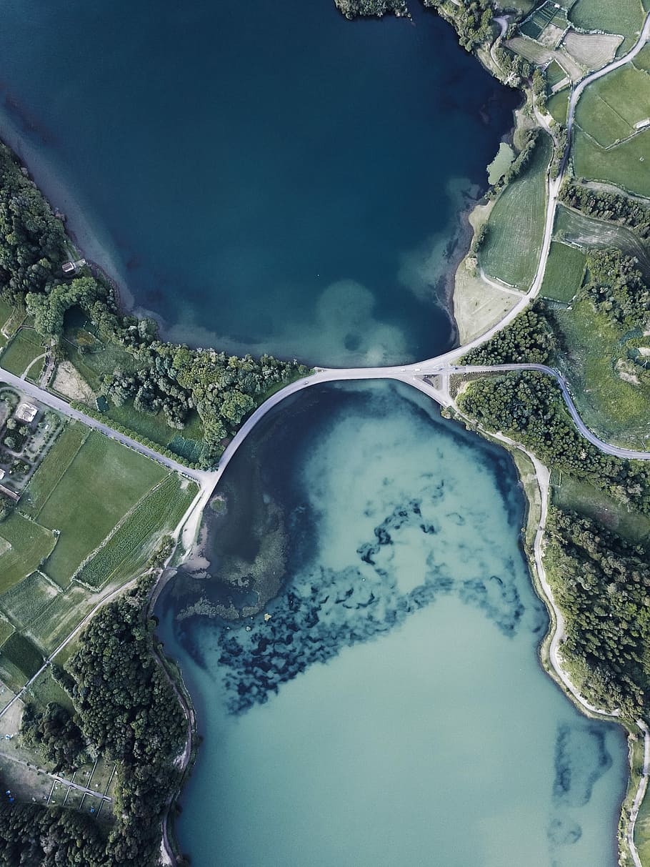 aerial photography of body of water between green land, high angel photography of body of water