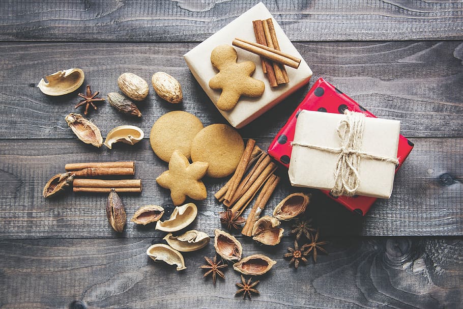flat lay photography of cookies, assorted nut shells and baked cookies with two white and red gift boxes on gray wooden surface HD wallpaper