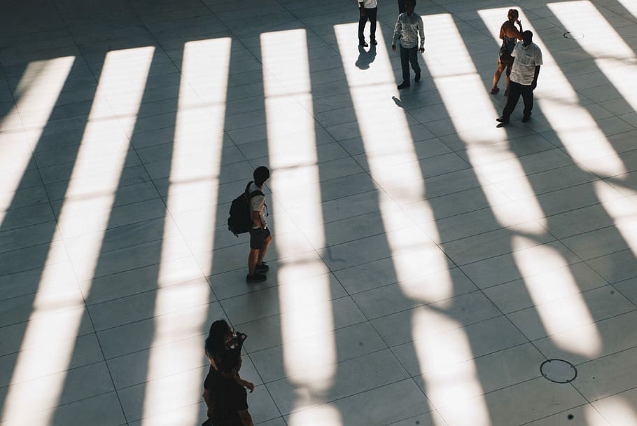 aerial photo of people walking on gray concrete pathway during daytime, six people standing on white concrete ground HD wallpaper