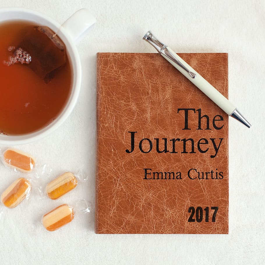 white and black click pen on The Journey by Emma Curtis book on table HD wallpaper