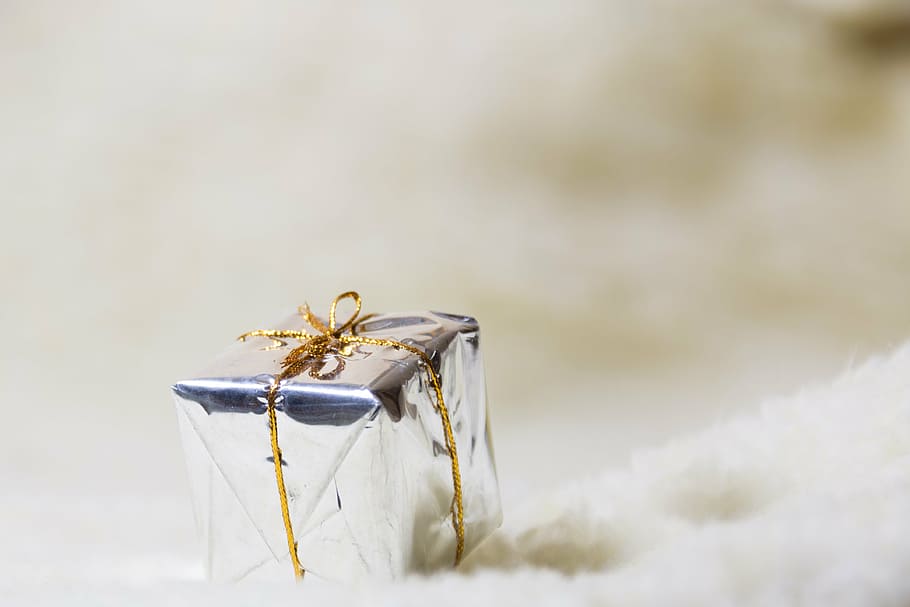 selective focus photography of silver gift box on white textile HD wallpaper