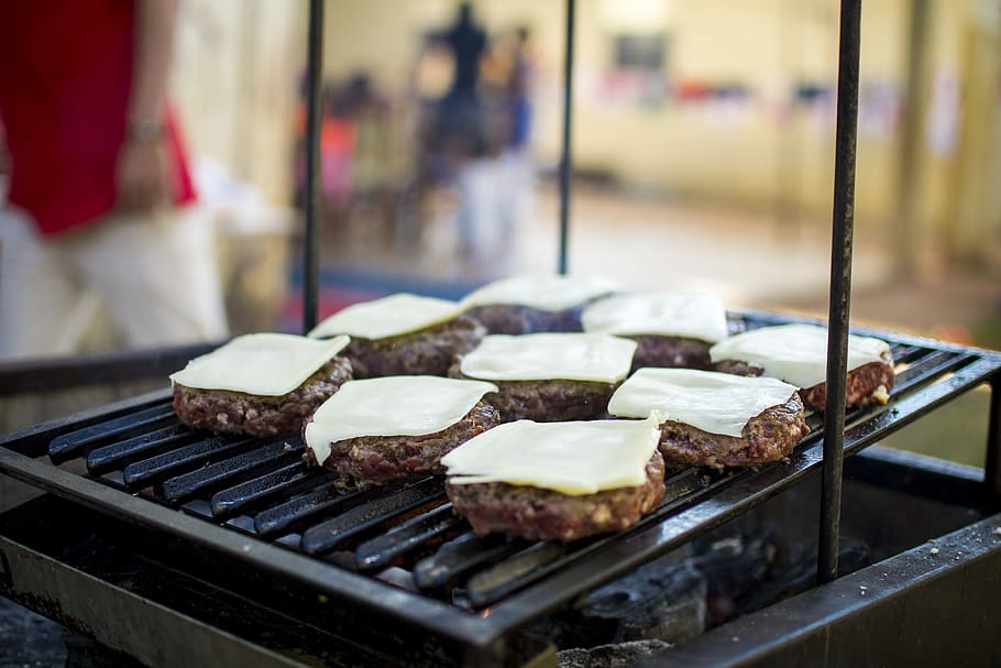 selective focus photography of meat patty with cheese on grill, grilled meat on metal grill