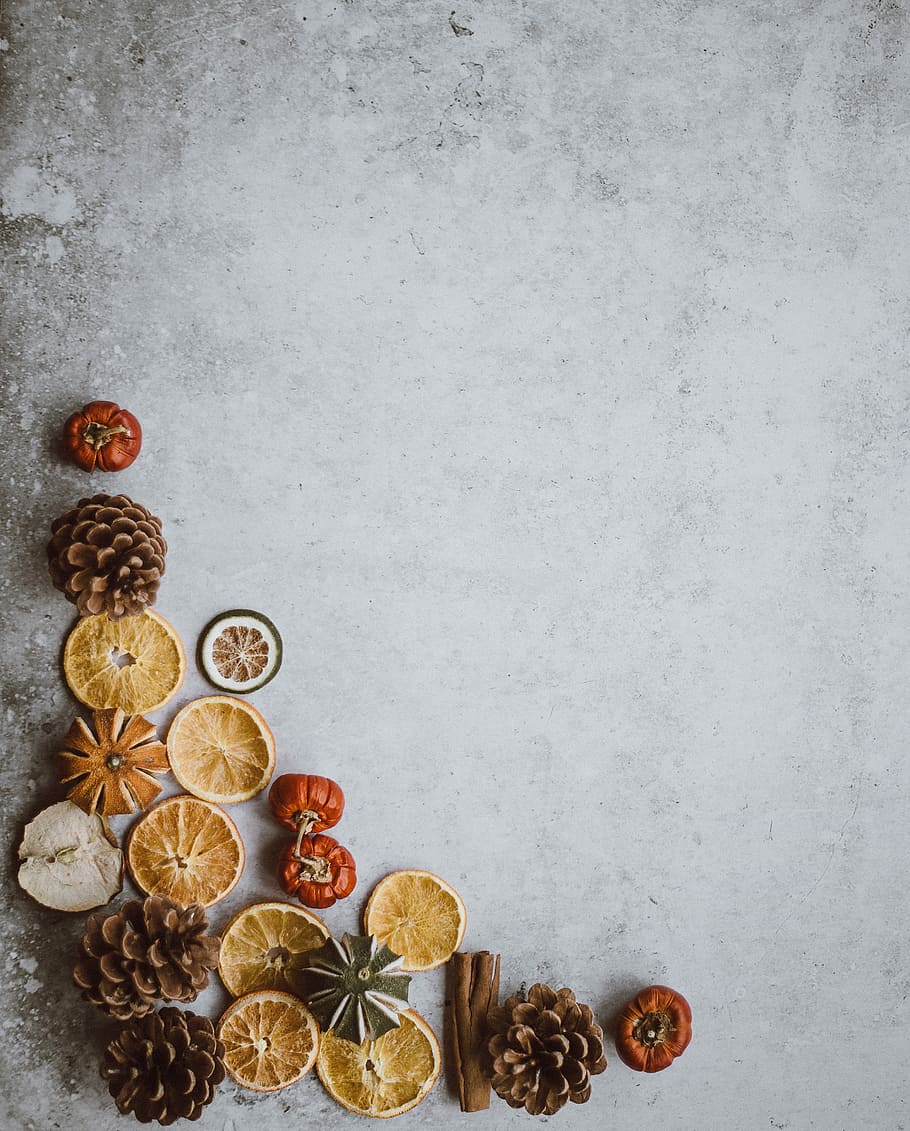 dried fruits on the corner, sliced fruit and pinecone on floor HD wallpaper