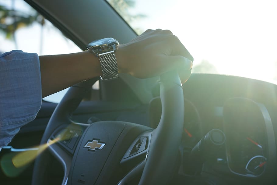 person driving Chevrolet car during daytime, hand, clock, handle HD wallpaper