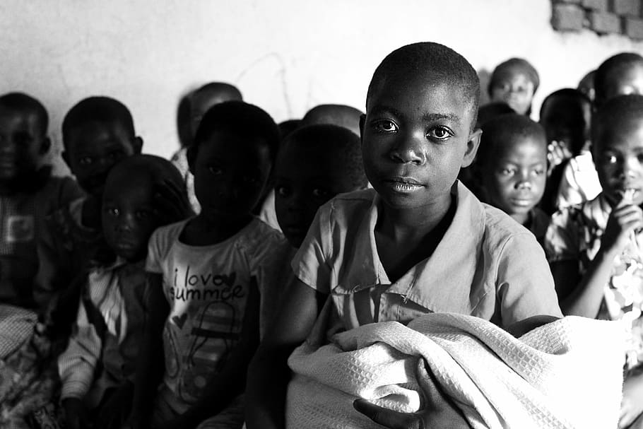 several children gather near wall, children of uganda, mbale