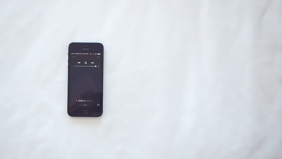 black iPhone 5 displaying music list, space, gray, white, bed HD wallpaper