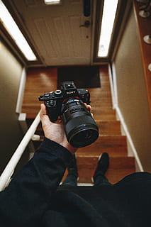 person holding black Sony DSLR camera, lens, photography, blur HD wallpaper