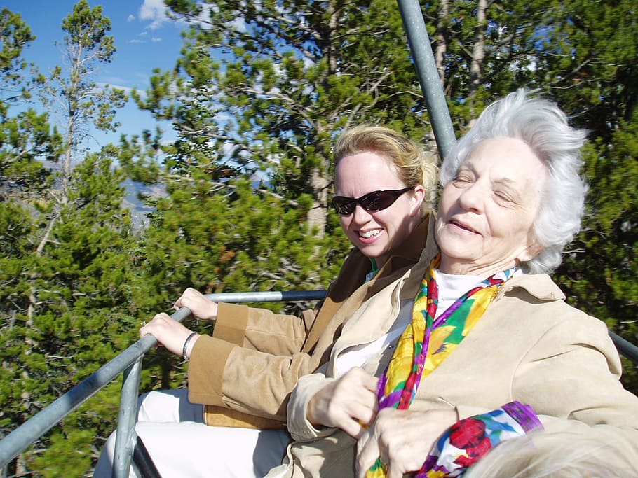 woman wearing brown jacket on amusement ride, grandma, old, senior