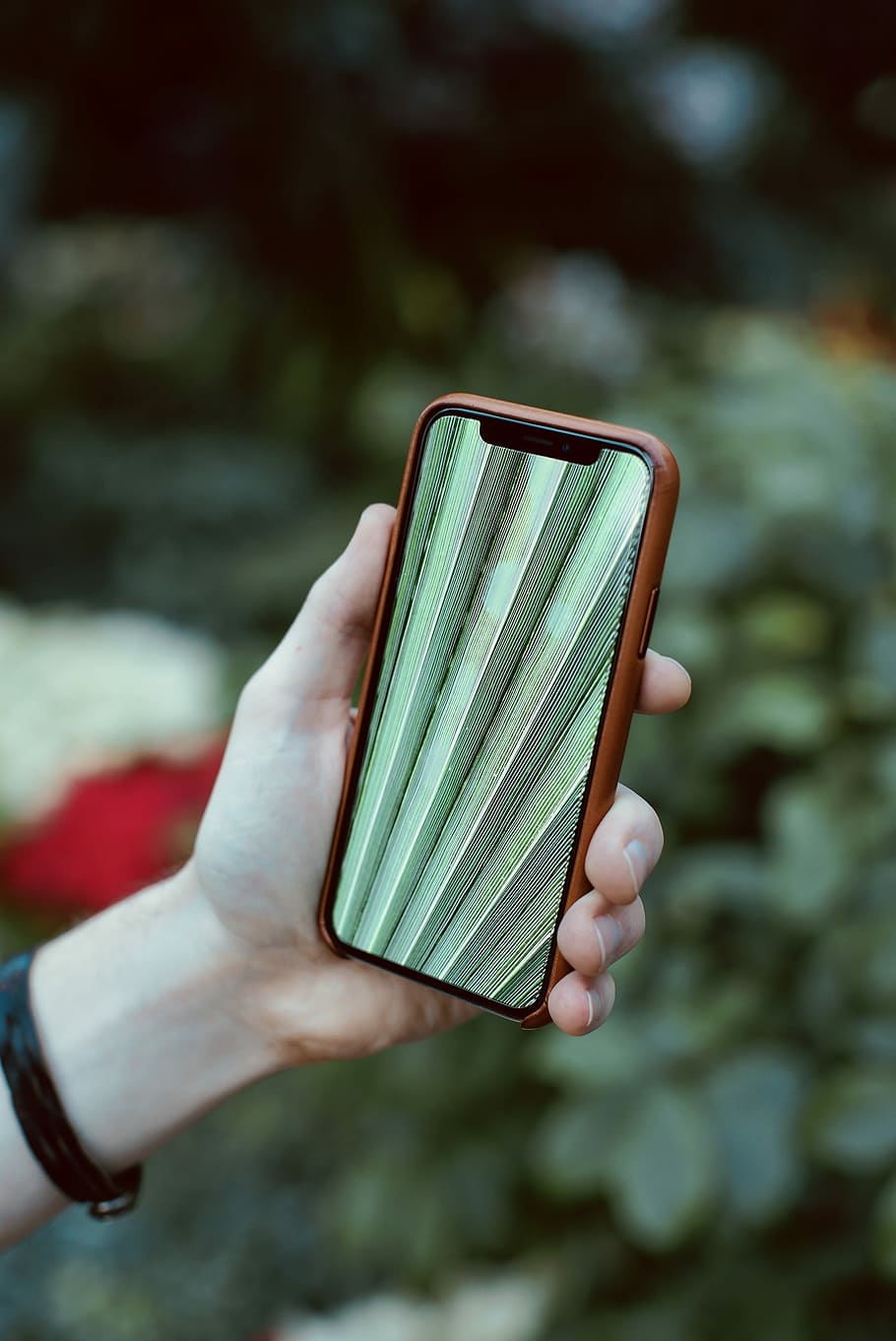 person holding space gray iPhone X and brown case, mobile phone HD wallpaper