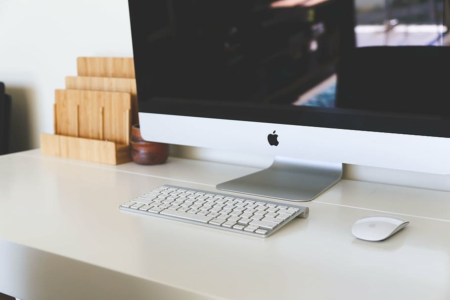 silver iMac with Magic Keyboard and Magic Mouse on white table HD wallpaper