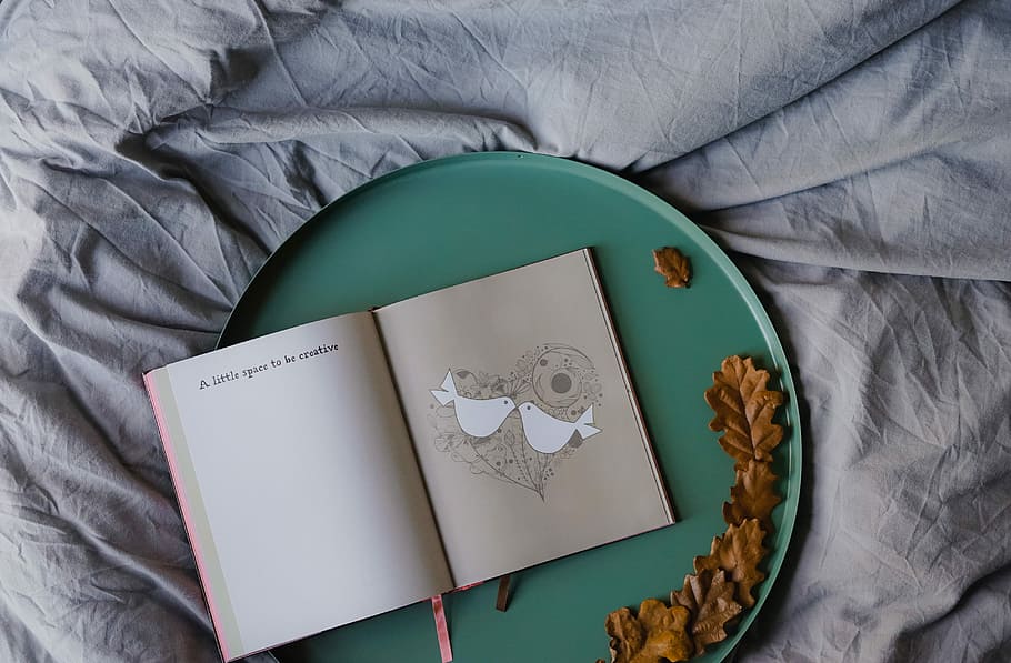 open book on round grey metal tray, leaves, bed, linen, furniture HD wallpaper