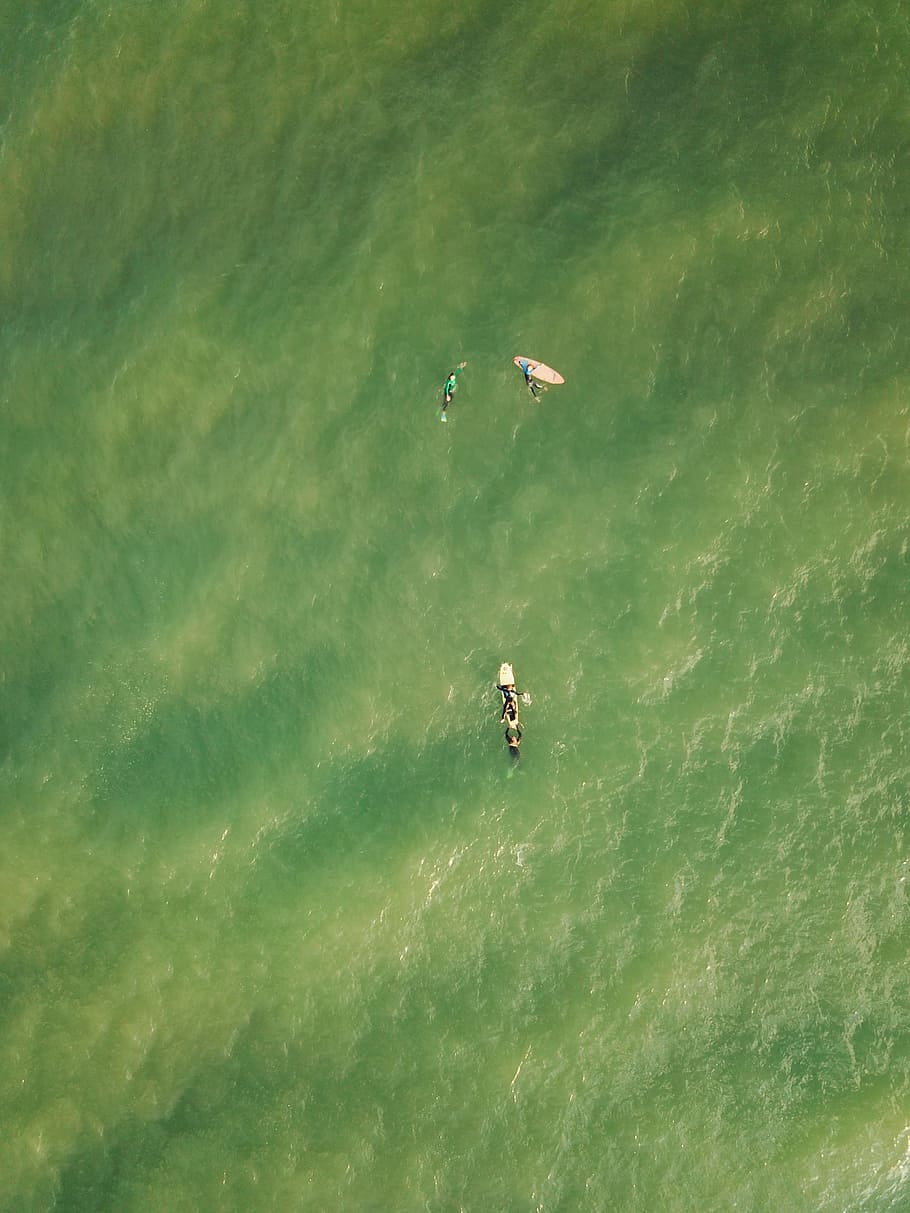 aerial photography of three person on surfing board floating above body of water, people surfing during daytime HD wallpaper