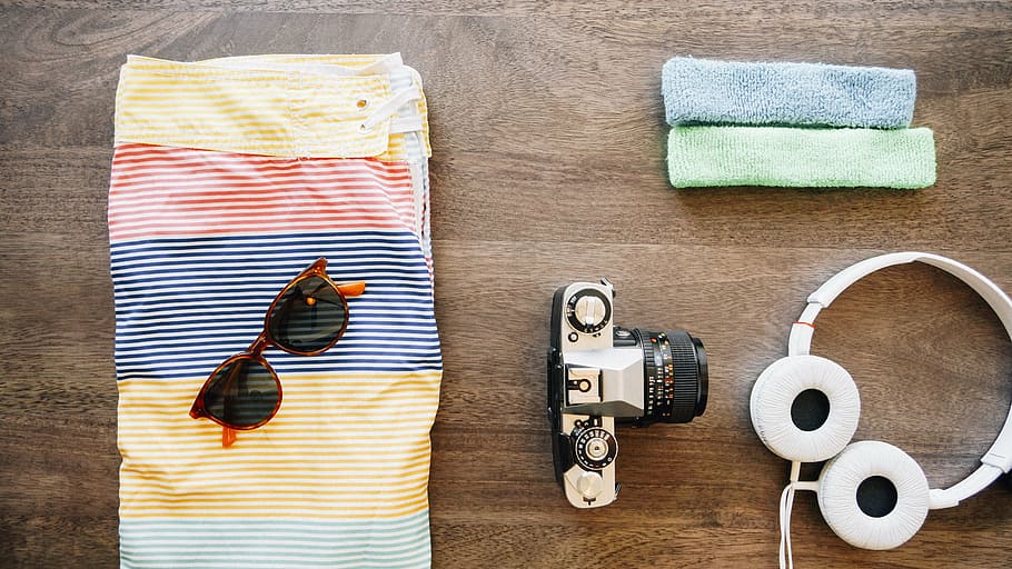 flat lay photography of camera, headphones, sunglasses, and board shorts, HD wallpaper