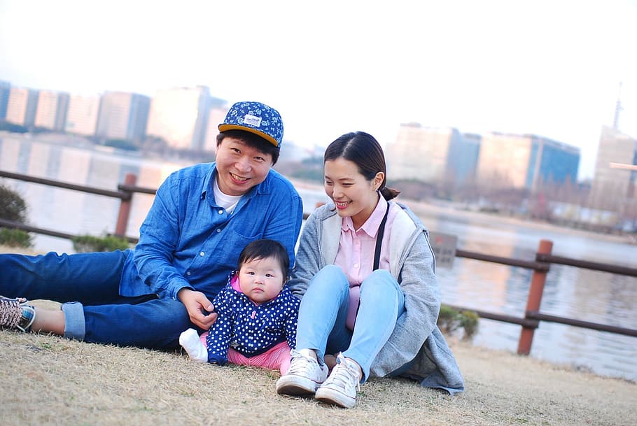 baby sitting between man and woman during daytime, family, korean