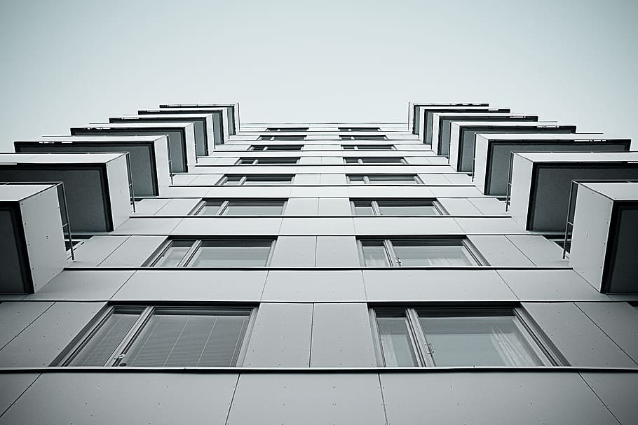 white painted concrete building, low-angle photography of high-rise building during daytime HD wallpaper