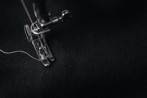 photo of gray sewing machine foot lock with thread on black cloth, closeup photo of sewing machine sewing black textile HD wallpaper