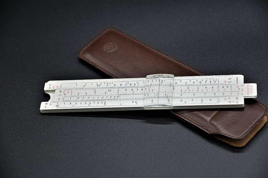 white ruler with brown case, slide rule, computing device, logarithmic