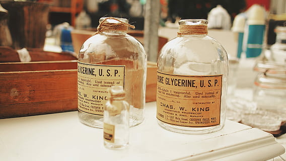 three empty clear bottles, two Glycerine U.S.P. glass bottles HD wallpaper