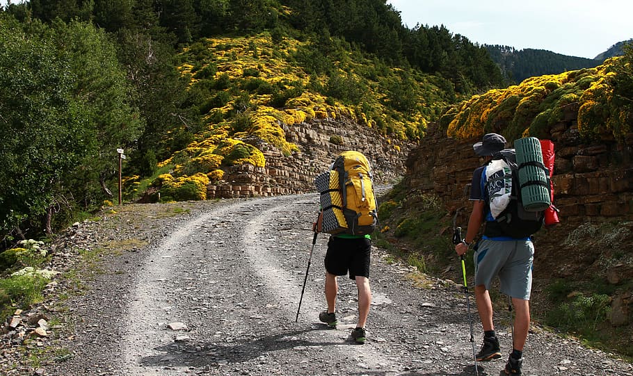 two men walking through rock formations, hike, backpack, backpackers