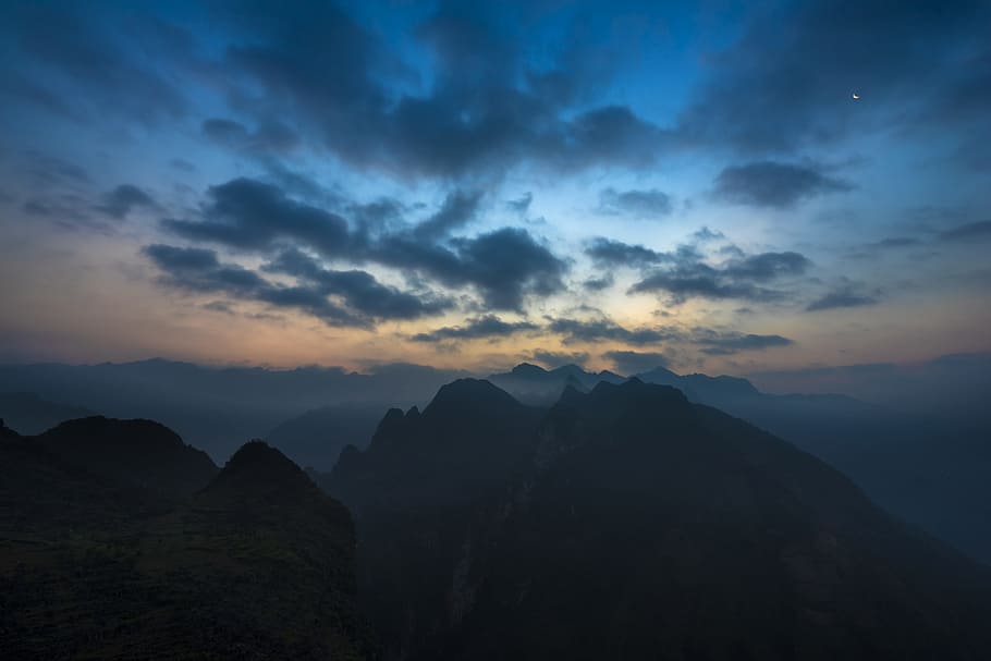 mountain peak during daytime, silhouette photography of mountains under nimbus clouds HD wallpaper