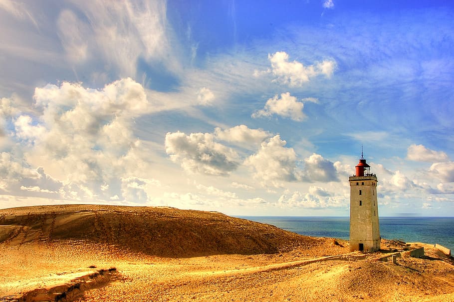 gray lighthouse on brown sand during blue cloudy day, rubric HD wallpaper