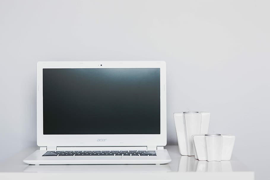White laptop with smartphone and headphones, notebook, mobile phone