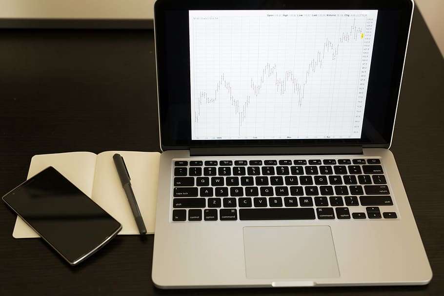 MacBook Pro on table, turned, beside, pen, smartphone, charts HD wallpaper