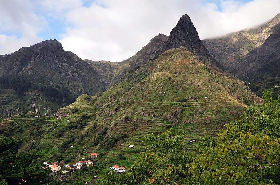 green-covered mountain under cloudy skill, madeira, volcanic