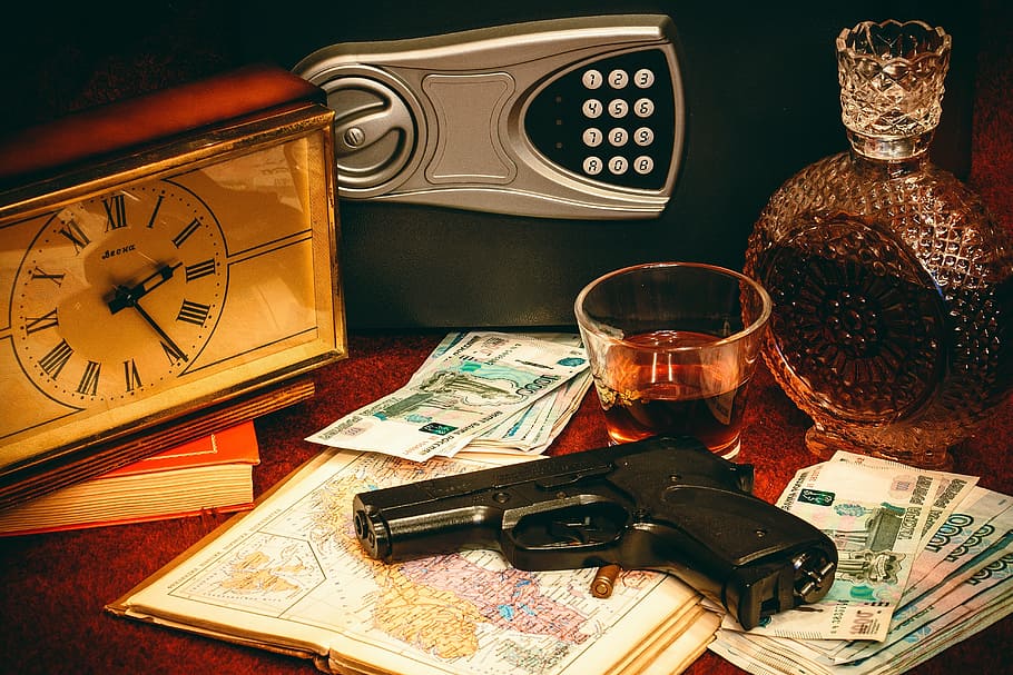 photo of pistol on top of map paper, safety deposit box, gun