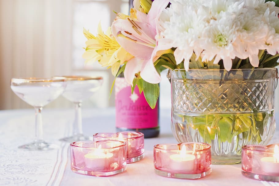 selective focus photography of tealight votive candles on table near floral arrangement and wineglasses, HD wallpaper