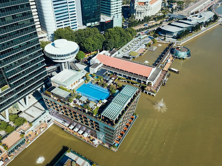 aerila view of buildings, bird's-eye view of building near body of water HD wallpaper