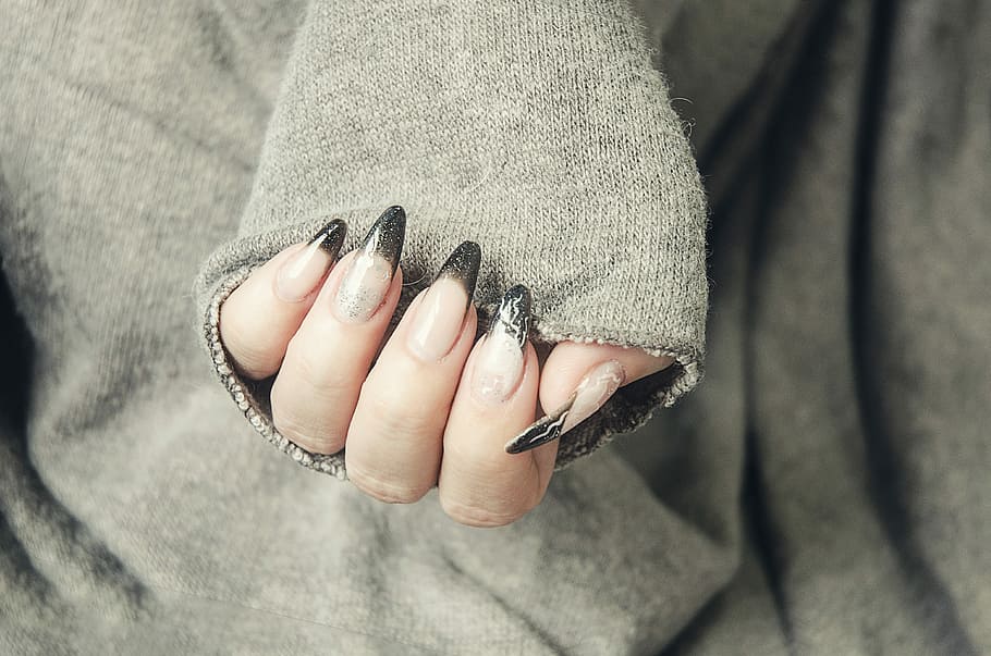 photograph of person with black manicure, black french, tips