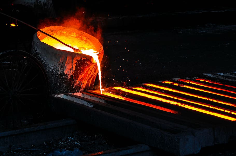 bin pouring molten metal unto rectangular container, iron, melt