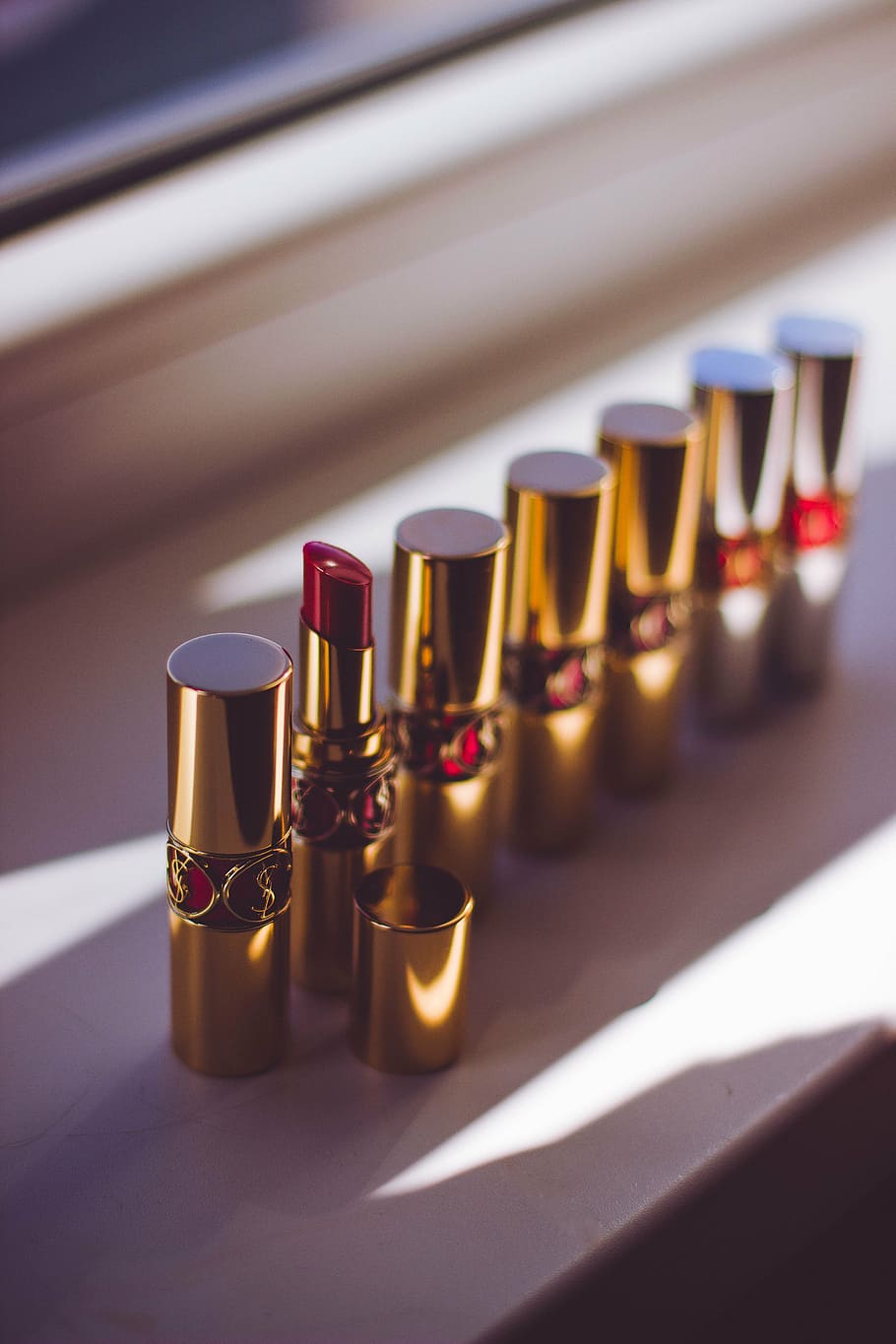 red lipsticks standing beside window, lipstick tubes, makeup, HD wallpaper