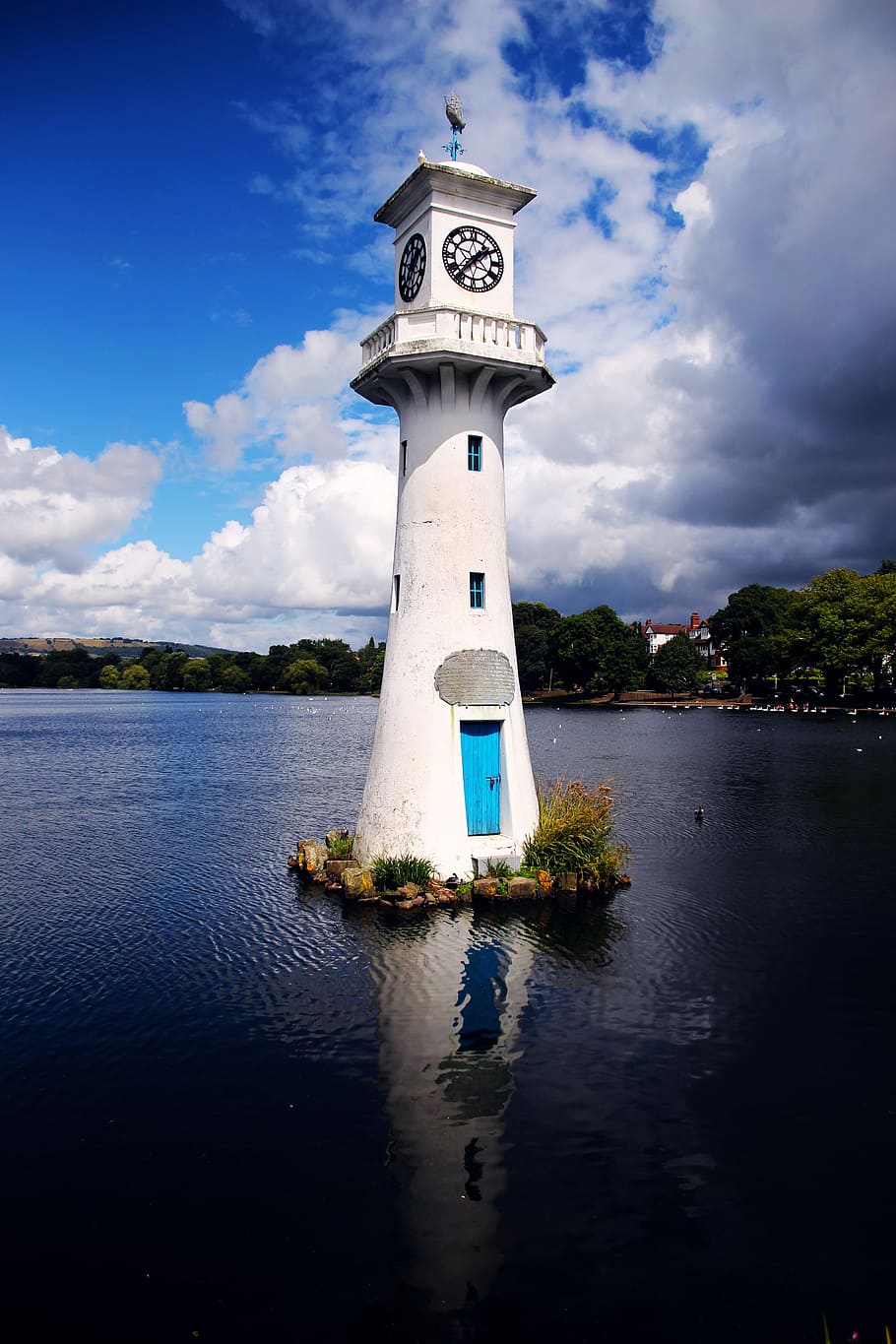 white concrete lighthouse on body of water, lake, sky, great