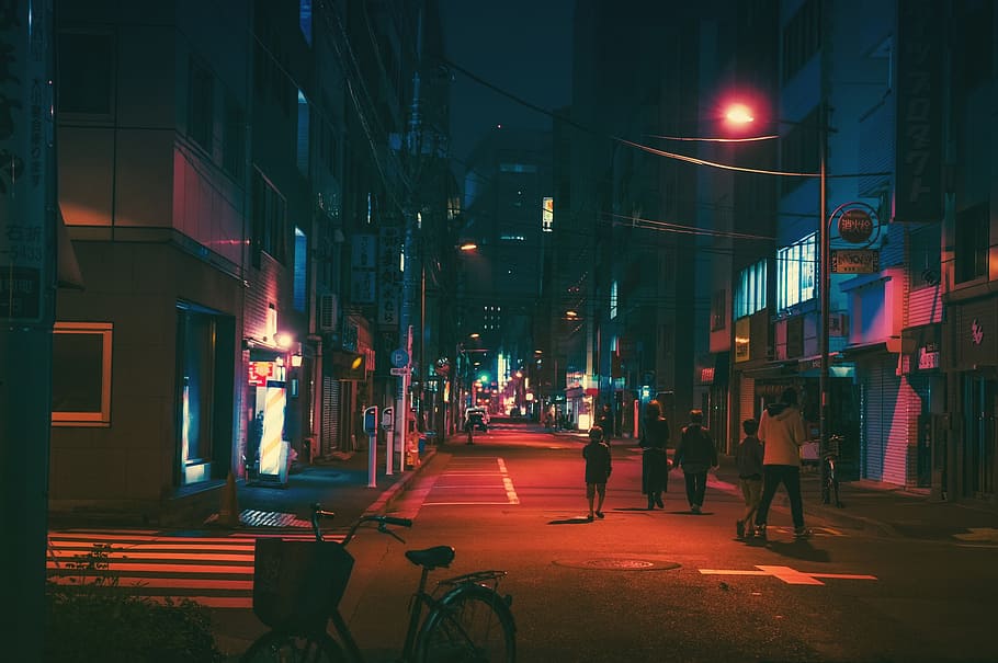 group of people near concrete building during nighttime, japan