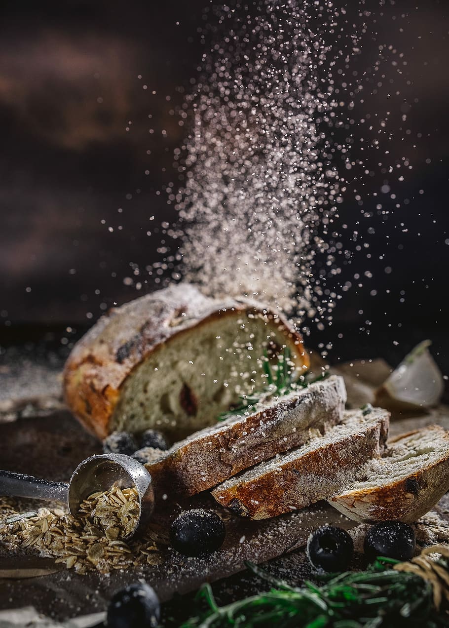sliced bread on table, wheat bread with pouring white powder HD wallpaper