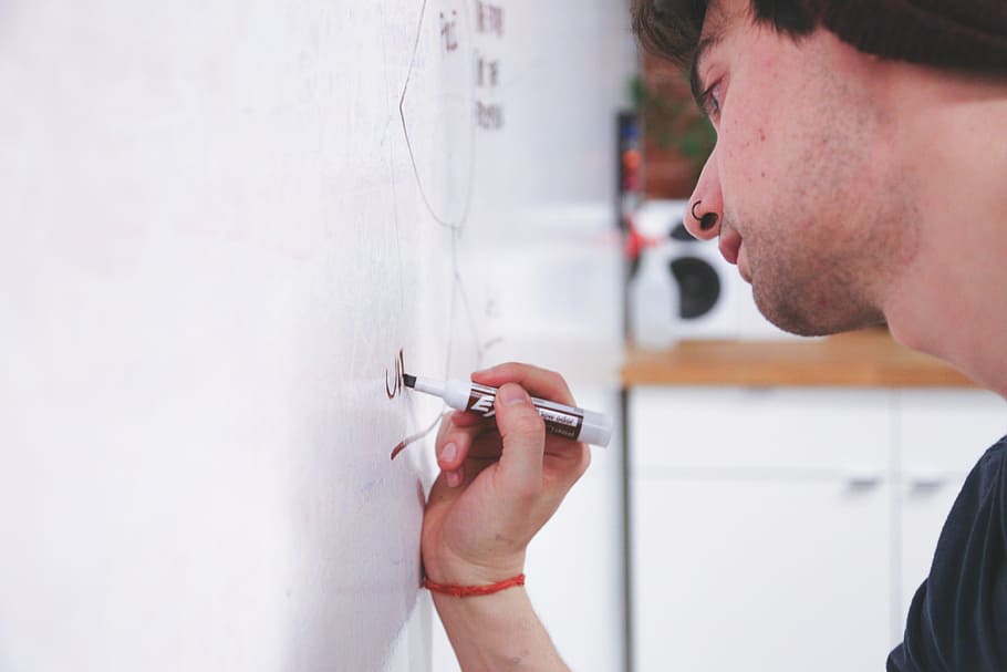 person holding black permanent marker, whiteboard, writing HD wallpaper