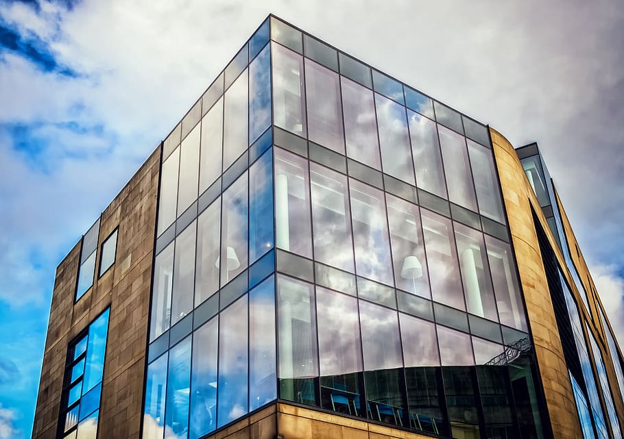 low angle of curtain wall building under white clouds at daytime HD wallpaper