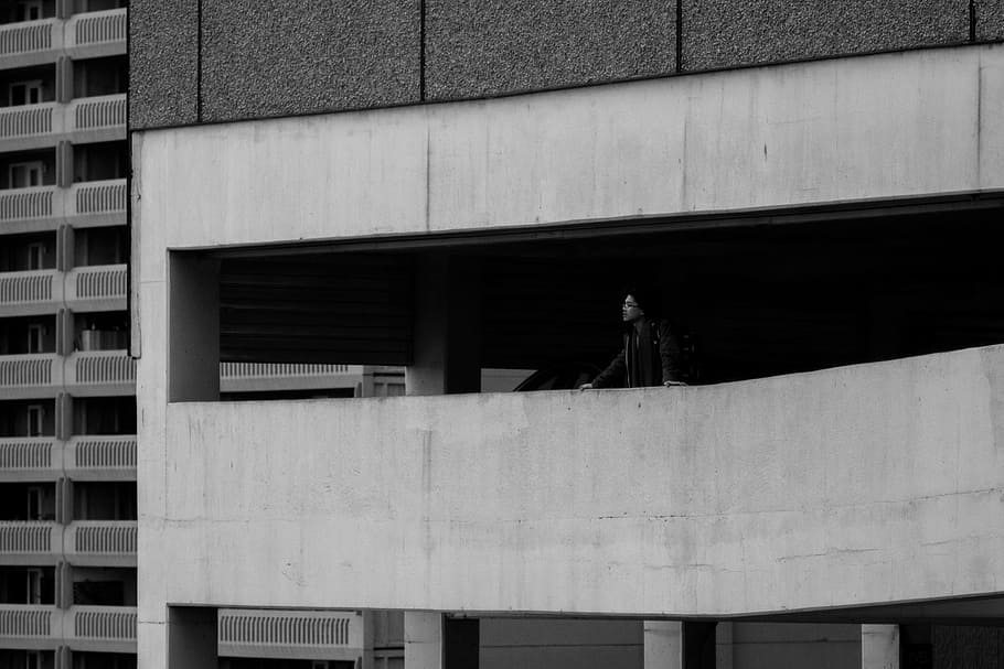 man standing in the building, grayscale, photo, concrete, parking garage HD wallpaper