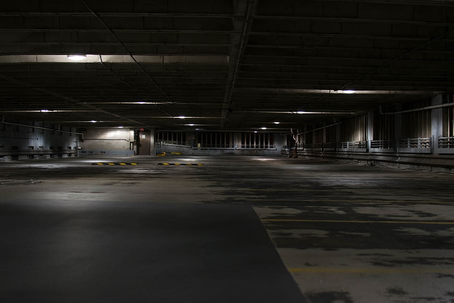 indoor parking space, park lot inside building photo, dark, concrete