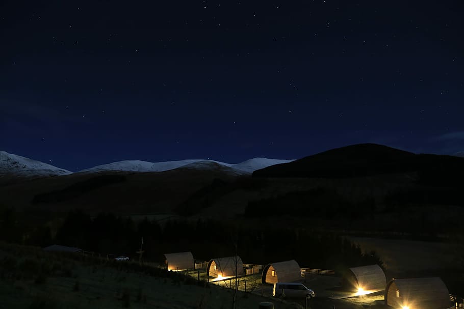 lighted houses during nighttime, landscape of mountain and houses during night HD wallpaper