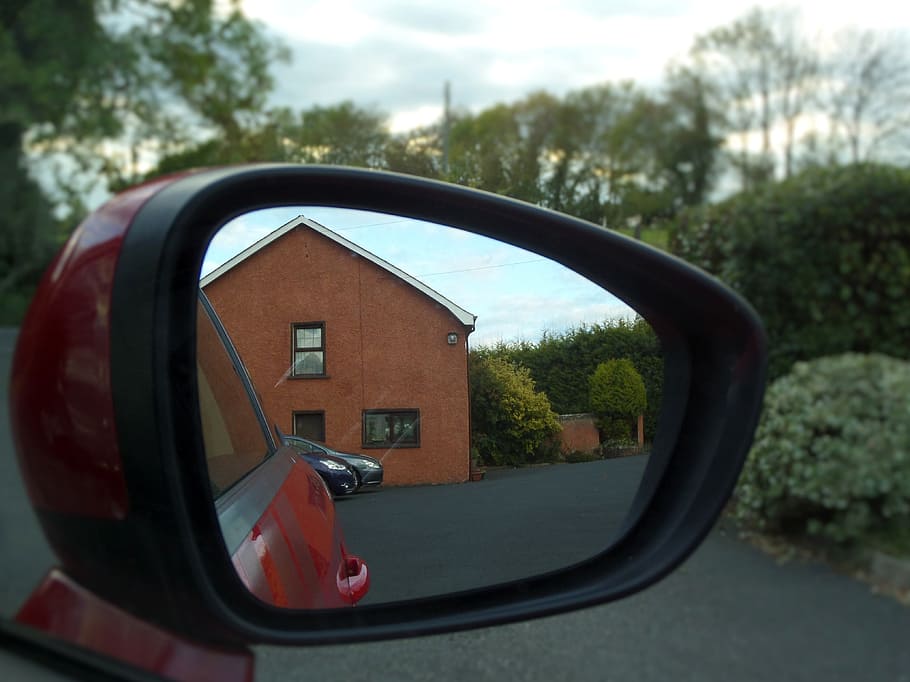 red wing mirror showing the reflection of brown house during daytime HD wallpaper
