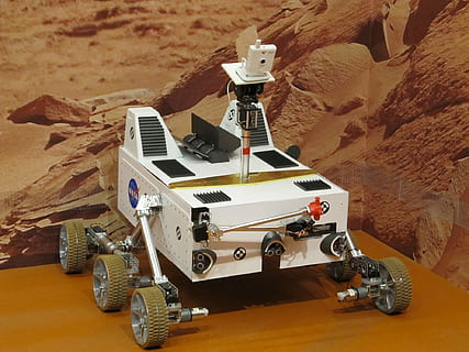 white robot on brown table, mars rover, exhibit, space, exploration HD wallpaper